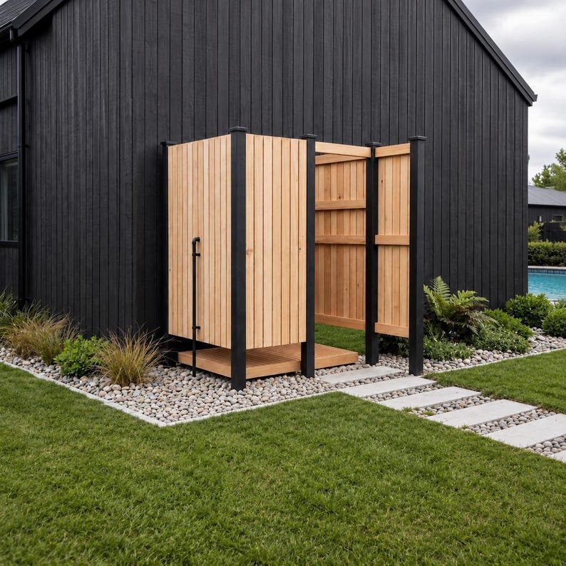 A timber shower enclosure with an open entrance, privacy screen and removable duckboard floor
